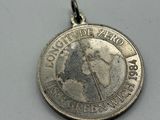 an image of a silver coin with a picture of a woman on it