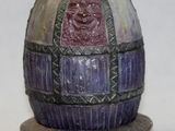 a purple and black egg with a purple face on it