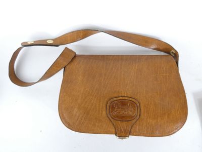 brown leather purse on white background with leather strap