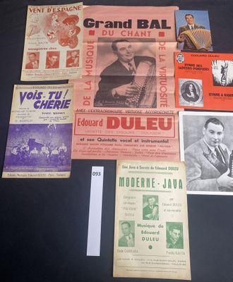 several old concert posters are displayed on a black table