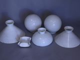 five white vases sitting on a table next to each other