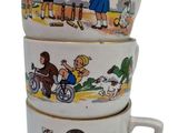 three coffee cups with cartoon characters on them stacked on top of each other