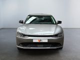 the front view of a silver car in a white room