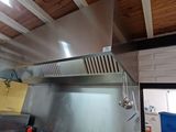 a kitchen with a stove, oven, and a sink in it