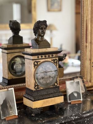 a picture of a clock with a bust of a man on top of it