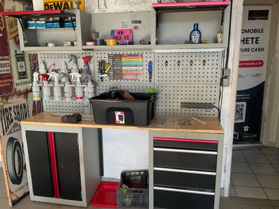 a workbench in a garage with a lot of tools on it