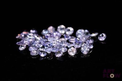 some very pretty purple and white diamonds on a black surface