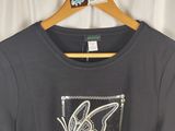 black t - shirt with a butterfly design on the front