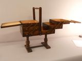 a small wooden desk with a drawer on it