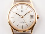 a gold wrist watch with a white face on a white surface