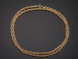 a gold chain bracelet with a clasp on a black background