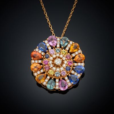 a close up of a necklace with multi colored stones on it