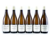 six bottles of wine are lined up on a white surface