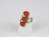 an image of a ring with three red coral beads on it