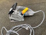 a cord and a tool on the ground next to a cord cutter
