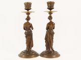 pair of antique bronze candlesticks with female figures on them