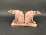 pair of pink ceramic figurines of a cat and a dog