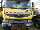 a yellow truck that is parked next to a cement truck