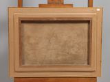 an old wooden easel with a painting on top of it