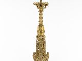 an ornate brass candle holder with a green top