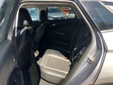 a car with the door open in a parking lot