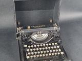 an old typewriter sitting in a case on a table