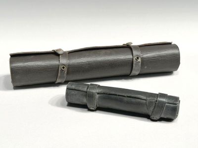 leather roll - up pencil case with metal clasps on a white background