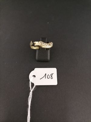 two gold wedding rings with a price tag on a black background