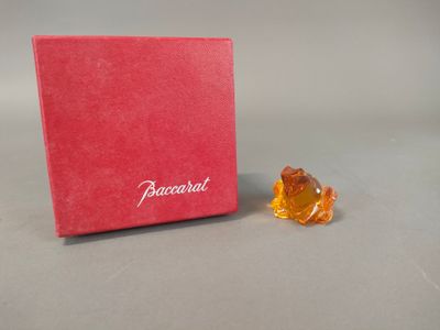 a small orange bear sitting next to a red box