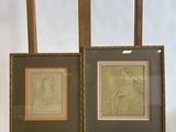 two framed drawings of a man and a woman on an easel