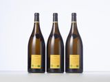 three bottles of wine sitting on top of a white table