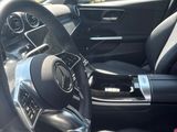 the interior of a car with a steering wheel and dashboard controls
