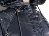 the jacket is shiny blue and has a hood that is attached to it
