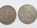 two silver coins, one with a cross and the other with a coat of arms