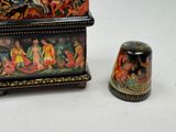 a small box and a thimble sitting on a table