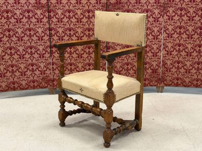 a chair that is sitting in front of a red wall