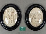 pair of black and white oval picture frames with figures in them
