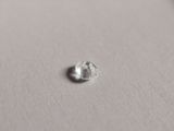 a close up of a single diamond on a white surface