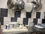 pots and pans hanging on the wall in the kitchen