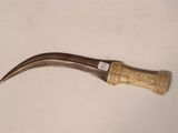 a small knife with a wooden handle on a table