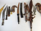 many different types of knives on a white surface