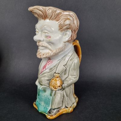 a figurine of a man with a book in his hand
