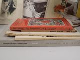 several books are stacked on top of each other on a table
