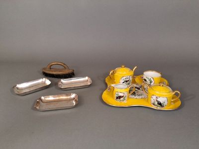 a small tray with a tea set and a brush on it