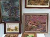 a table with a lot of paintings on it