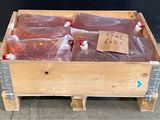 a wooden box filled with red liquid and plastic bags