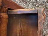 a wooden box with a handle on the ground