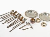 a lot of silver spoons and spoons on the table