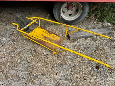 a yellow cart that is sitting on the ground