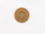 a gold coin on a white surface with a white background